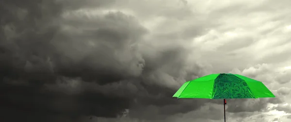 stock image Umbrella under cloudy sky