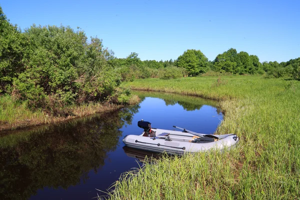 Rubber boat on coast river — Stock Photo, Image