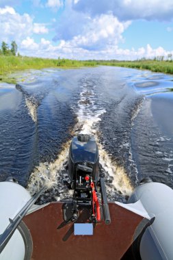 Motor boat on small river clipart