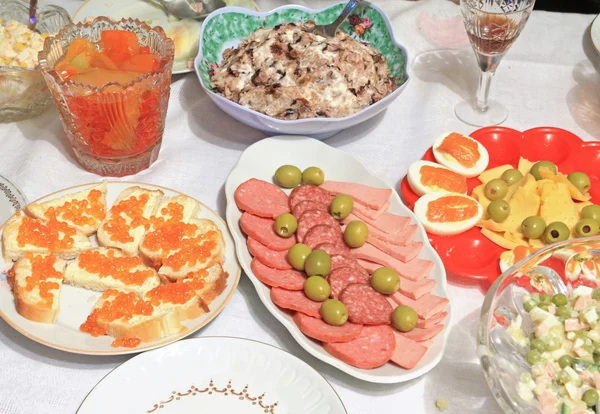 stock image Varied food-stuffs on white tablecloth