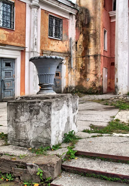 Urna decorativa perto de edifícios antigos — Fotografia de Stock