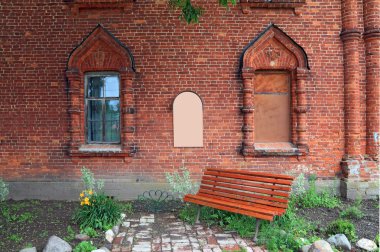 Red bench in the churchyard clipart