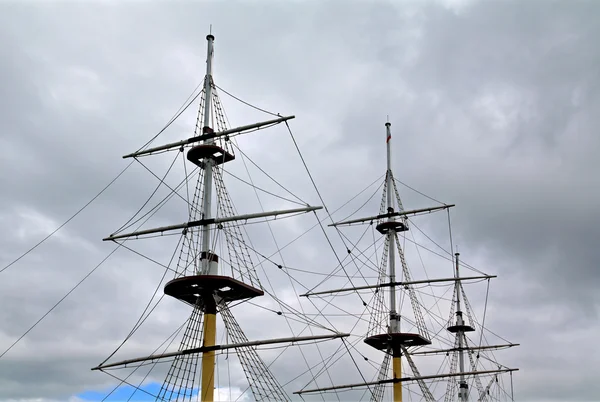 Ship masts on cloudy sky — Stock Photo, Image