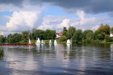 Sailboat on river clipart