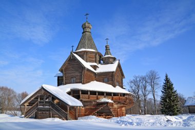 Wooden chapel in winter village clipart