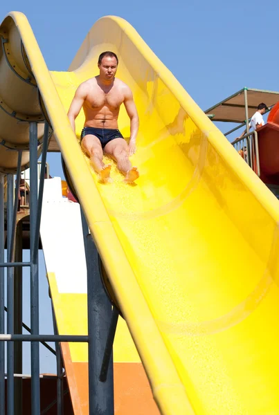 Man riding a water slide — Stock Photo, Image