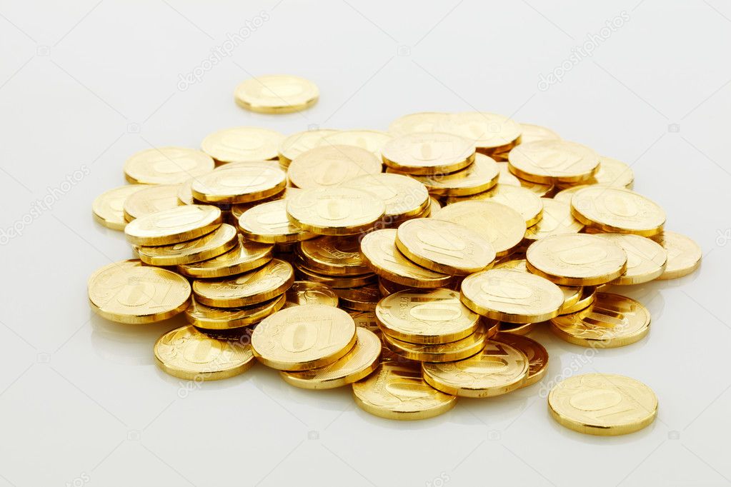 Pile of golden coins isolated on white