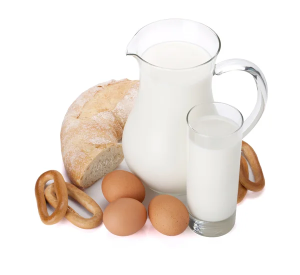 stock image Milk jug, glass, eggs and bread