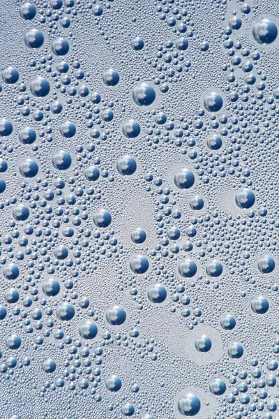 Gotas de água sobre um fundo cinza-azul — Fotografia de Stock