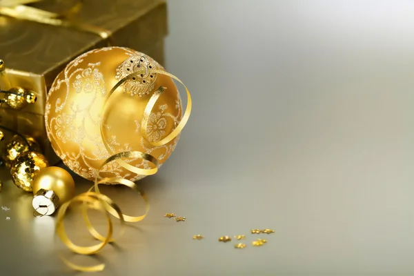 Gold christmas ball and gift — Stock Photo, Image