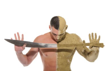 Young man half smeared with clay with sword clipart