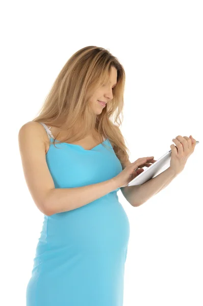 Счастливая беременная женщина с таблеткой — стоковое фото