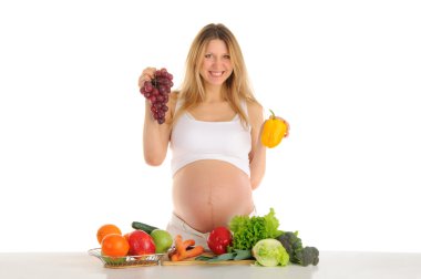 Happy pregnant woman with fruits and vegetables clipart