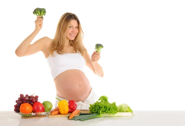 Танцующая беременная женщина с фруктами и овощами — стоковое фото