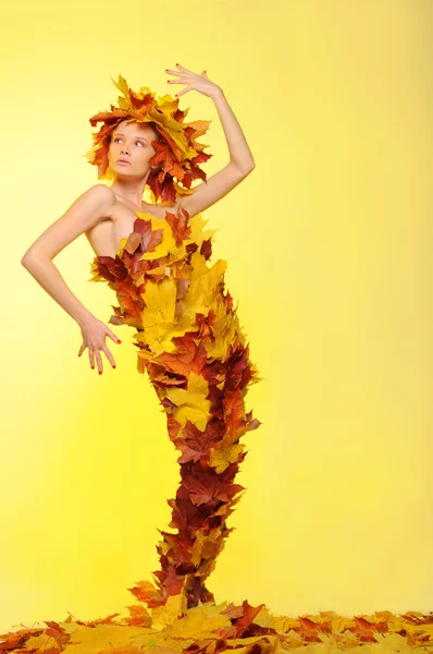 Woman in gown of autumn leaves — Stock Photo, Image