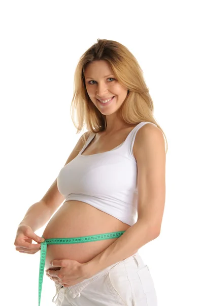 Šťastná žena těhotná břicho míra — Stock fotografie
