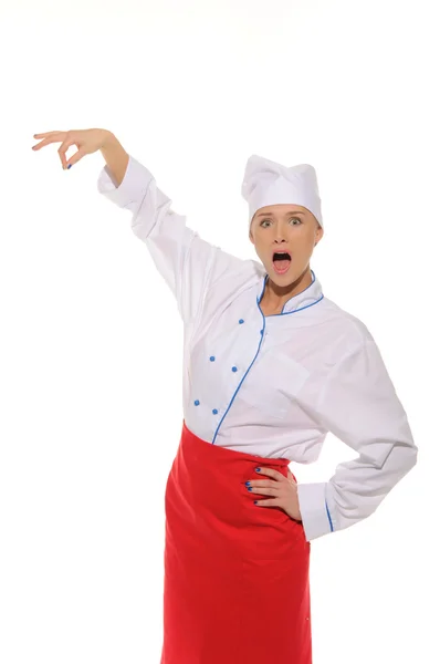 Surprised female chef picks up — Stockfoto