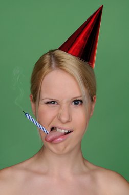 Woman with candle extinguished and festive cap