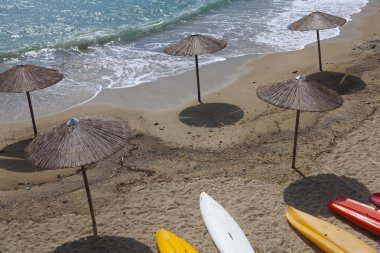 Beach with canoe in Greek island clipart