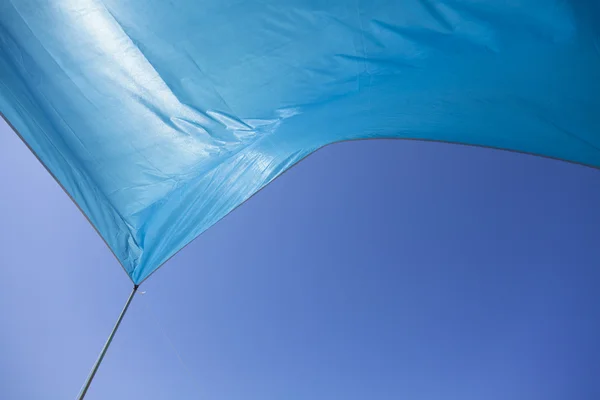 Blaues Zelt winkt in den blauen Himmel — Stockfoto