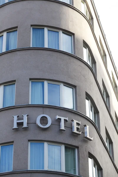 Hotel sign in exterior view on a rounded front of building — Stock Photo, Image