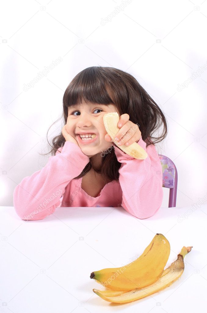 Little girl eating banana Stock Photo by ©gvictoria 6851832