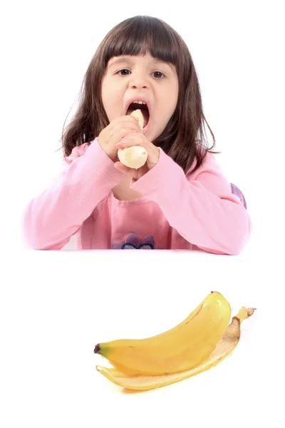 Mała dziewczynka jedzenie banana — Zdjęcie stockowe
