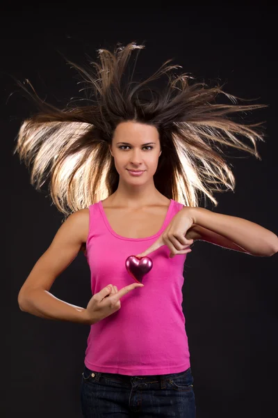 Beautiful young female holding a heart — Stock Photo, Image