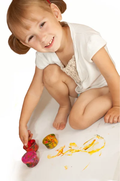 Cute smiling little girl is drawing — Stock Photo, Image