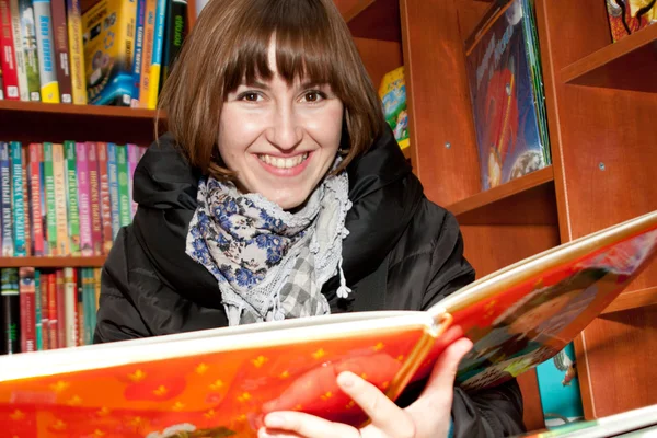 stock image Happy young woman read a book