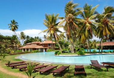 Swimming pool near villas at the popular hotel, Bentota, Sri Lan clipart