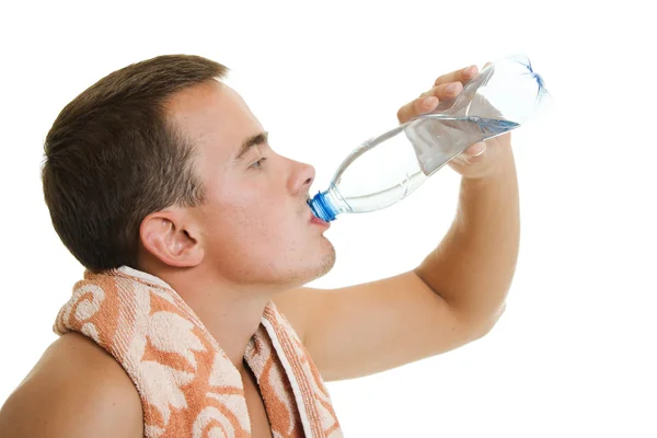 Man with towel drinking water — Stock Photo, Image