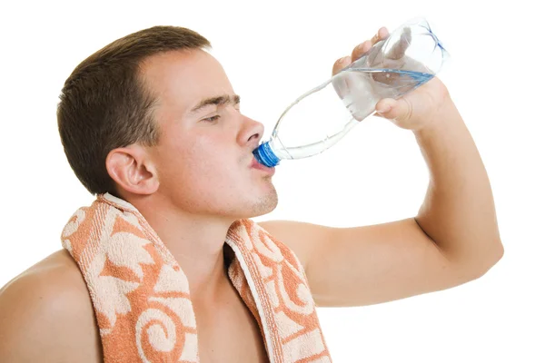 Man with towel drinking water Stock Picture