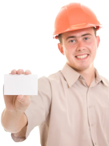 Businessman in helmet with visit card in his hand. — Stock Photo, Image