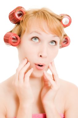 Woman in curlers moans on a white background. clipart