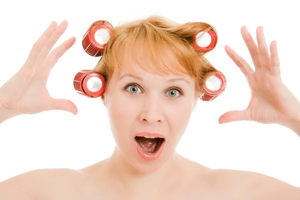 Woman in curlers moans on a white background. — Stock Photo, Image