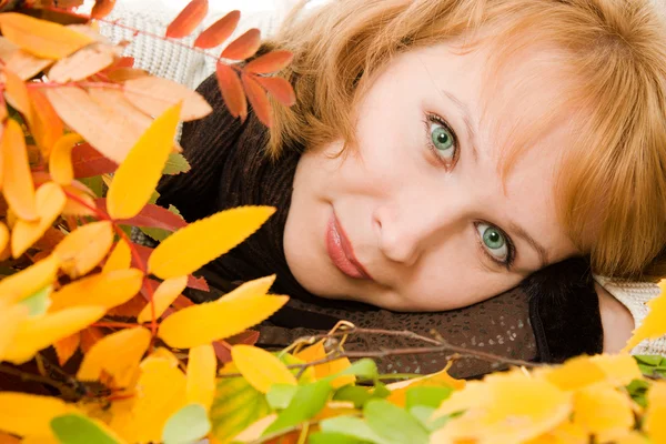 Vrouw in herfst bladeren op een witte achtergrond. — Stockfoto