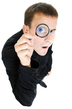 Funny man looking through a magnifying glass. clipart