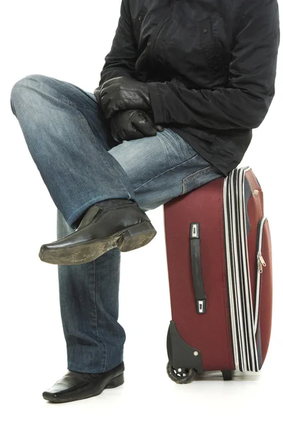 Businessman sitting on a suitcase. — Stock Photo, Image