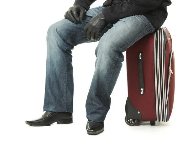 Businessman sitting on a suitcase. — Stock Photo, Image