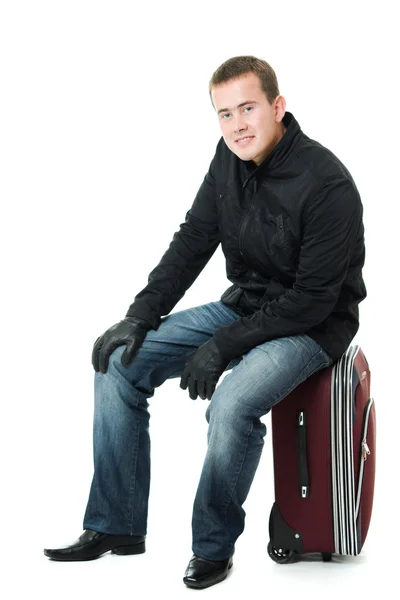 Empresário sentado em uma mala . — Fotografia de Stock