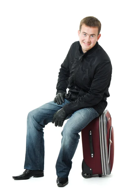 Affärsman som sitter på en resväska. — Stockfoto