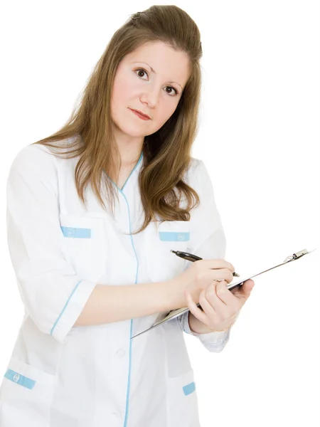 Vrouwelijke arts schrijven op de plaat document op een witte achtergrond. — Stockfoto