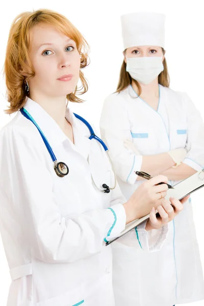 Duas mulheres médicos em um fundo branco . — Fotografia de Stock