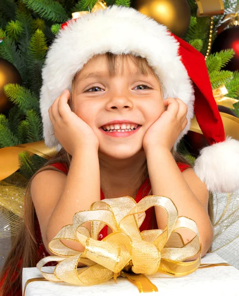 Pretty girl with present near the Cristmas tree — Stock Photo, Image