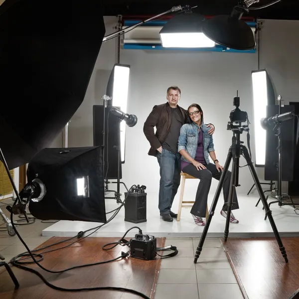 Businessman and woman in a modern photo studio — Stok fotoğraf