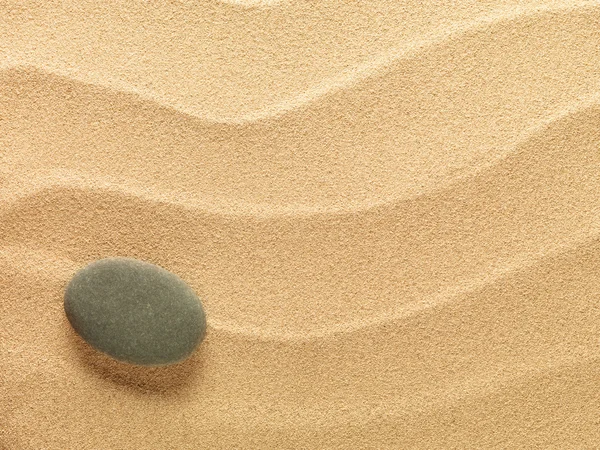 Beach sand background with stone — Stock Photo, Image
