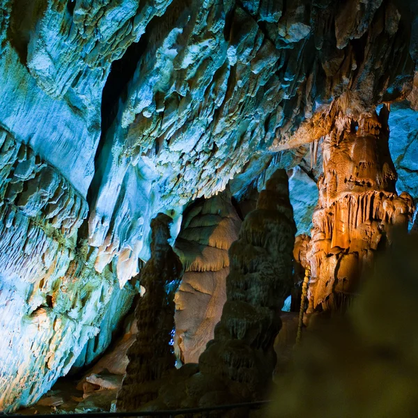 Cave stalactites and formations and a caver — Stock Photo, Image
