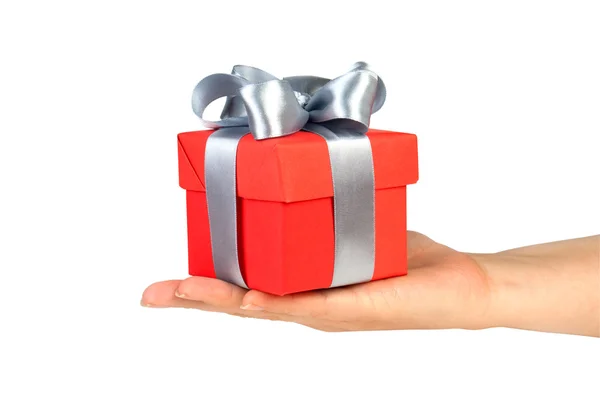 Gift box with ribbon in hand Royalty Free Stock Photos