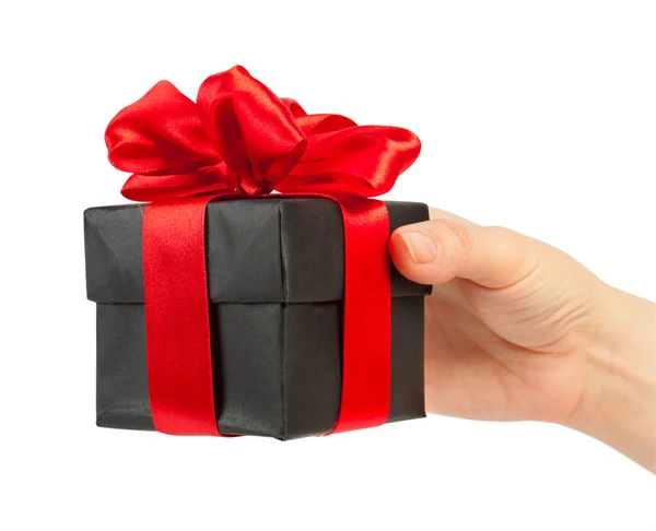 Gift box with ribbon in hand — Stock Photo, Image